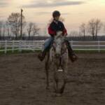 Skipper and her owner riding in the arena.